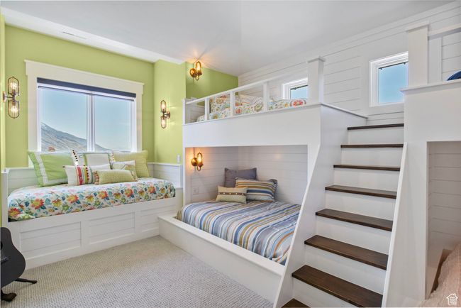 Bedroom with a decorative wall, carpet, and wainscoting | Image 114