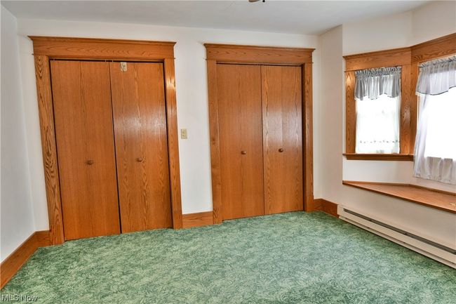 Unfurnished bedroom featuring carpet and a baseboard radiator | Image 18