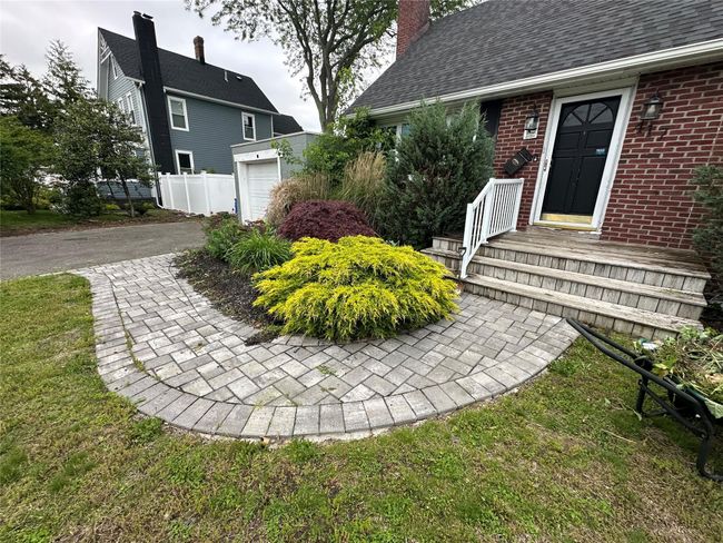 View of yard with a garage and driveway | Image 11