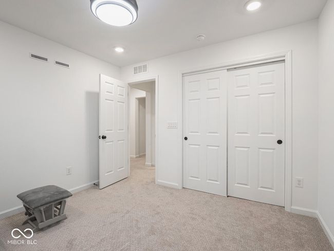 unfurnished bedroom featuring light colored carpet and visible vents | Image 45