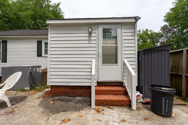 Exterior space with entry steps, central air condition unit, and fence | Image 15