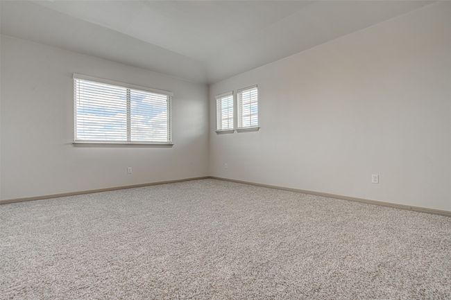 Carpeted empty room with vaulted ceiling and baseboards | Image 22