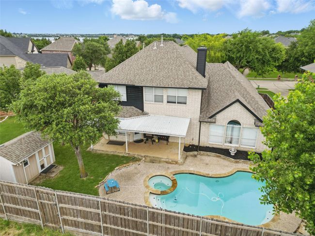 View of swimming pool featuring a patio area, a fenced backyard, and a pool with connected hot tub | Image 34