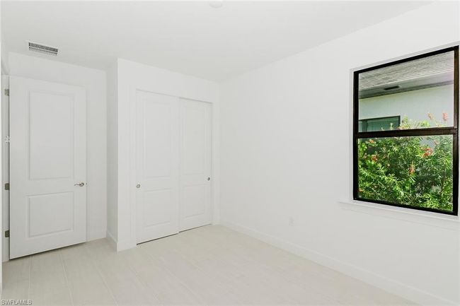 Unfurnished bedroom with baseboards and a closet | Image 9