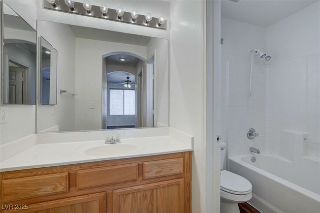 Bathroom with toilet, shower / bathtub combination, and vanity | Image 17