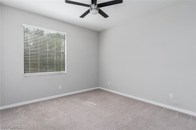 Carpeted spare room with ceiling fan | Image 13
