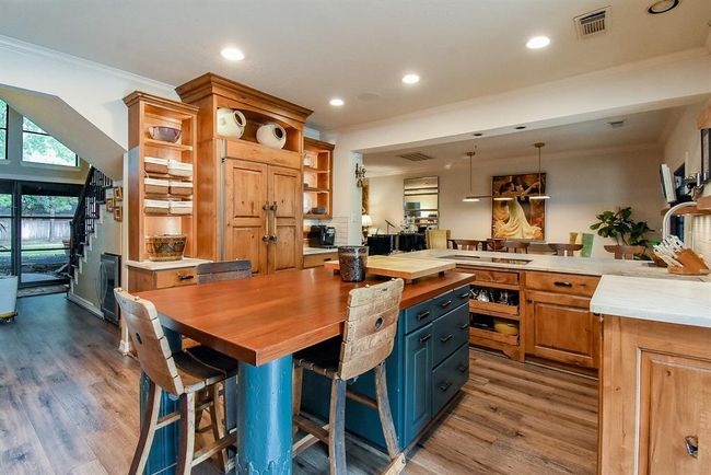 This kitchen has wonderful storage and the beautiful built in refrigerator wrapped in Alder wood to match the custom cabinets. | Image 16