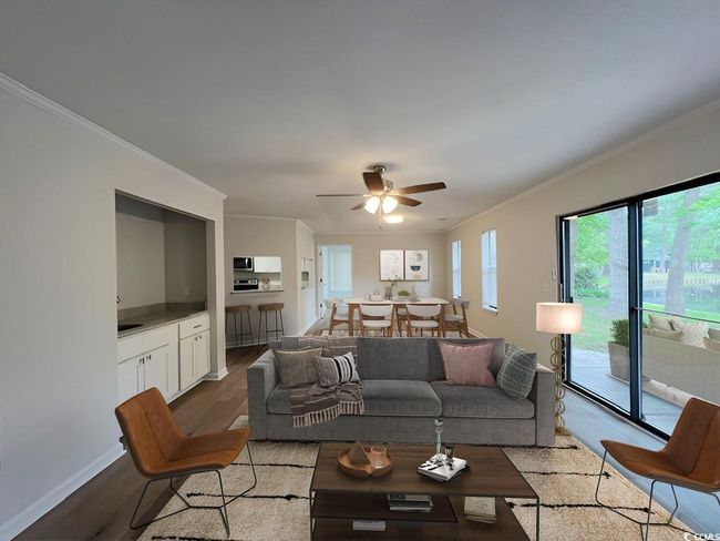 Living area with ceiling fan, wood finished floors, baseboards, and ornamental molding | Image 33