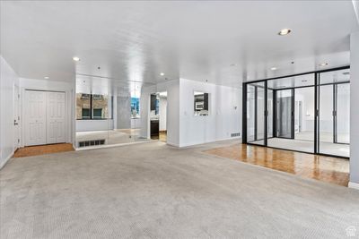 Unfurnished living room with light colored carpet | Image 3