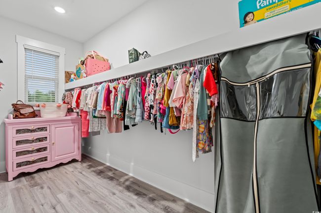 Walk in closet featuring light wood-style floors | Image 27