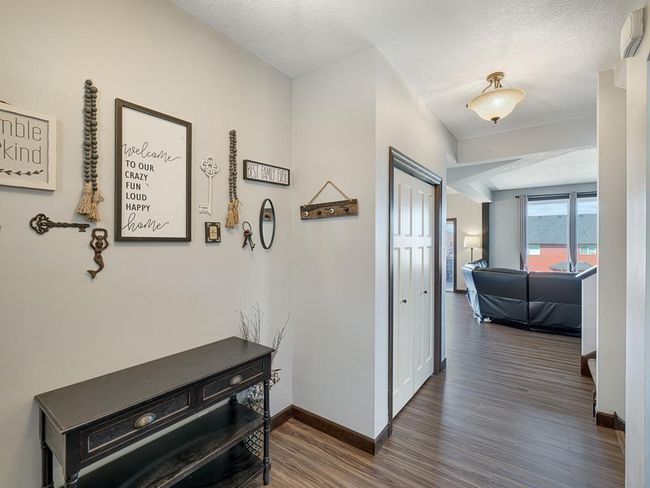 The foyer has closets, bench and table space, so you're never struggling to put on your shoes while juggling your keys or coffee! | Image 12