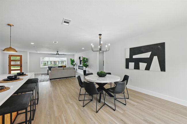 Dining space with light wood finished floors, baseboards, a chandelier, ceiling fan, and recessed lighting | Image 17