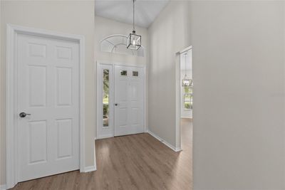 This Foyer is a welcoming space with new lighting and has lots of storage. | Image 2