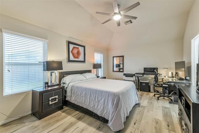 The secluded Primary Suite includes a spacious, serene bedroom with high ceilings and modern fan. | Image 18