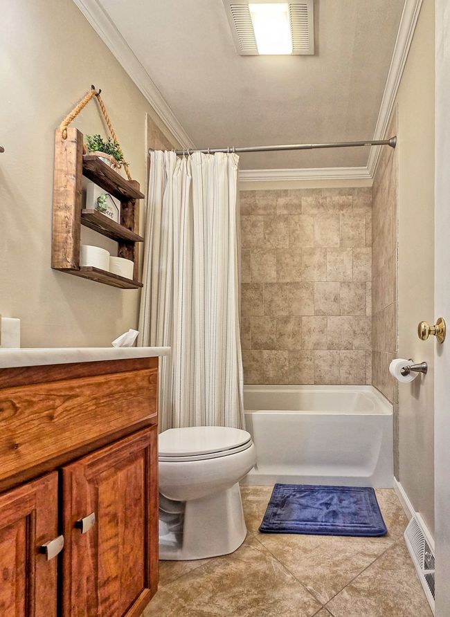 Hall bath with neutral tile, Tub/shower combination. | Image 20