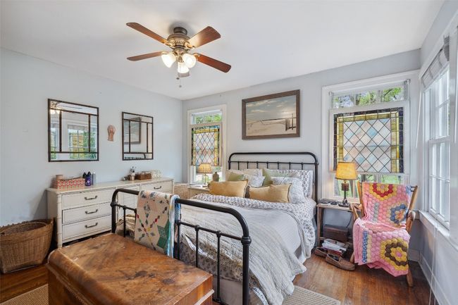 Bedroom #1 with beautiful stained glass windows, real hardwood floors, and tons of natural light | Image 32