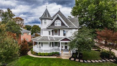 Victorian-style house with a front yard and a porch | Image 1