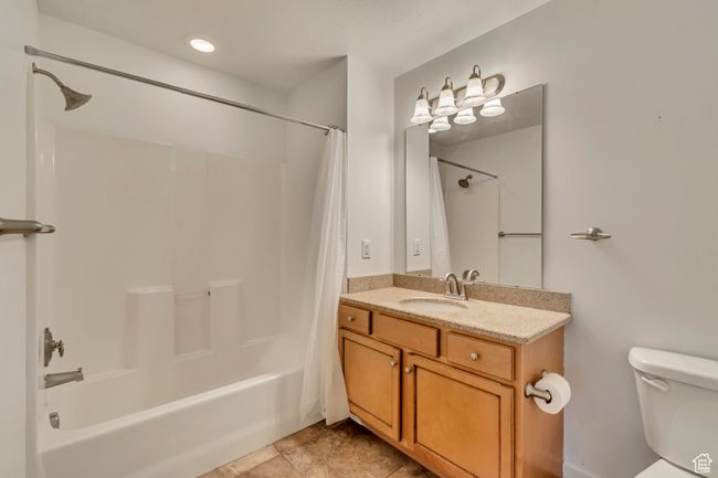Full bath featuring toilet, shower / bath combo with shower curtain, and vanity | Image 20