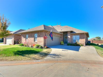 Single story home with a front yard and a garage | Image 1