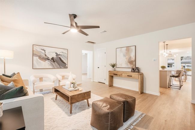 Living area with light wood finished floors and ceiling fan | Image 4