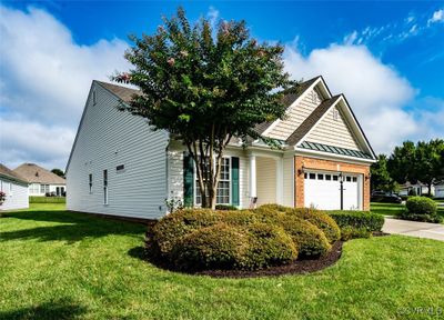 View of front of home with a garage and a front lawn | Image 3