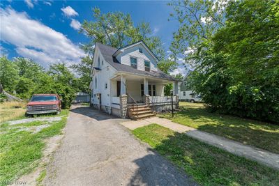 Bungalow featuring covered porch and a front yard | Image 2