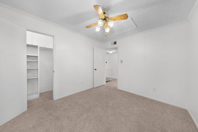 Upstairs bedroom 2 with updated carpet, walk-in closet and ceiling fan. | Image 17