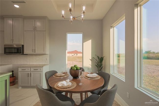 Dining area with a chandelier and light tile patterned floors | Image 23