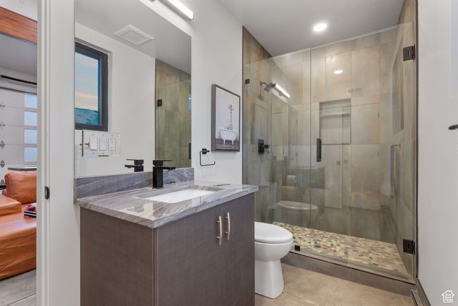 Full bathroom with vanity, tile patterned floors, a stall shower, and recessed lighting | Image 78