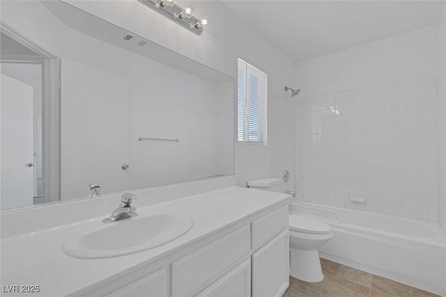 Bathroom with vanity and shower / tub combination | Image 17
