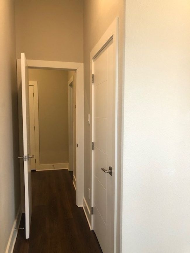 Hallway featuring dark wood-type flooring and baseboards | Image 18