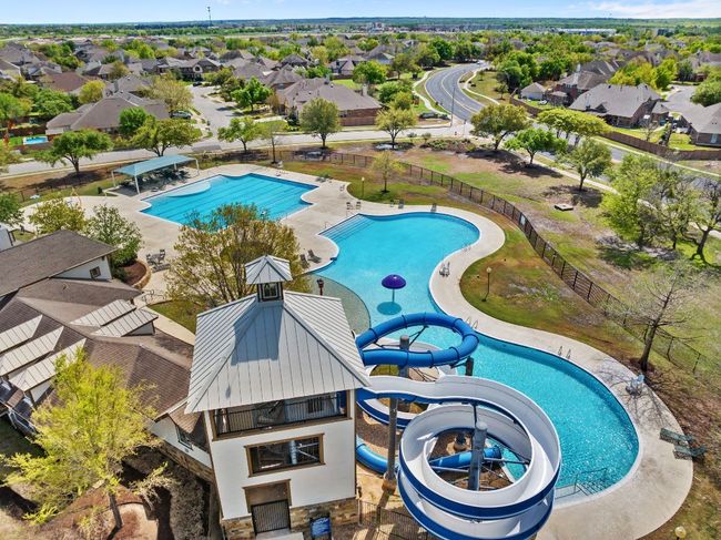 Community pool with a water slide. | Image 32