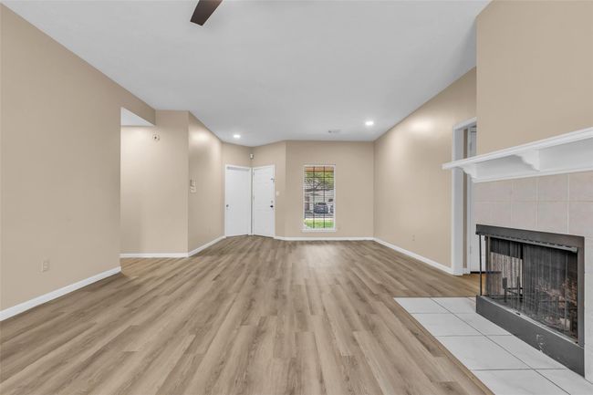 Living room and den facing the front door. | Image 7