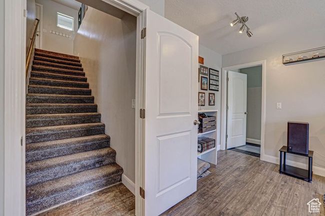 Stairway with baseboards and wood finished floors | Image 8