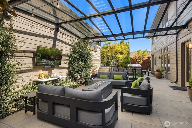 The backyard is a true rarity in West of Market: enjoy a covered, light-filled outdoor space for all-season entertaining, a beautiful turf yard, a relaxing hot tub and an exceptionally rare 4-car garage. | Image 32