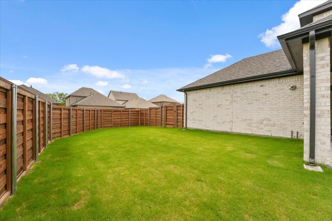 View of fenced backyard | Image 26