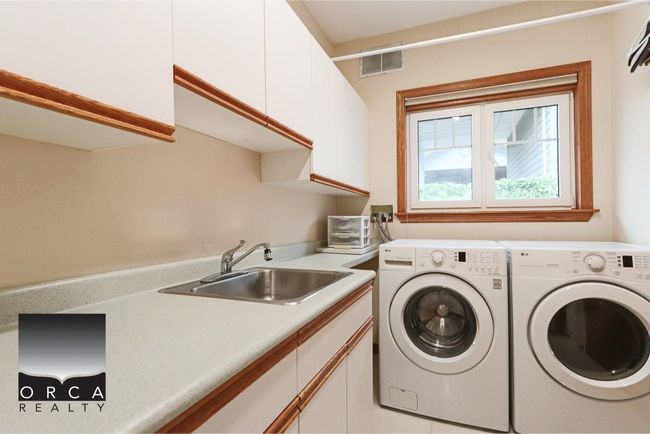 Washroom with cabinet space and washer and dryer | Image 17
