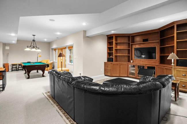 Relax in the spacious media room with custom built-ins, perfect for movie nights, gaming, or hosting guests in comfort. | Image 36