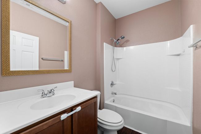 Bathroom with shower / bath combination, vanity, and toilet | Image 34