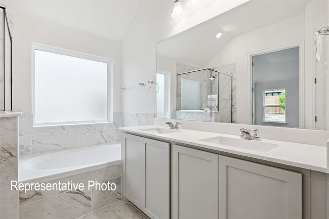Bathroom with a bath, vaulted ceiling, a sink, and a marble finish shower | Image 13