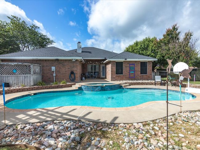 View of pool featuring a patio and a pool with connected hot tub | Image 33