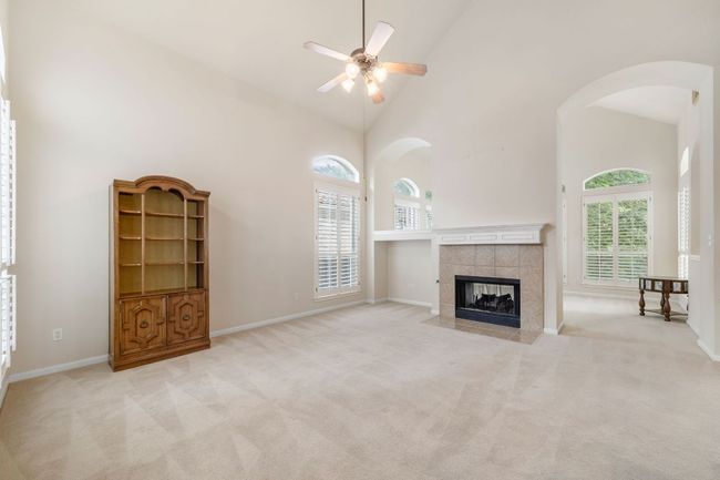 Vaulted ceilings, double sided fireplace, oversized windows and arched walkways | Image 5