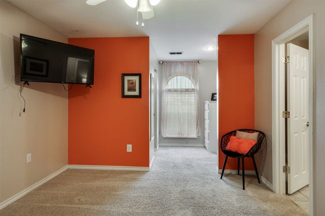 Living area featuring carpet floors, visible vents, baseboards, and ceiling fan | Image 18
