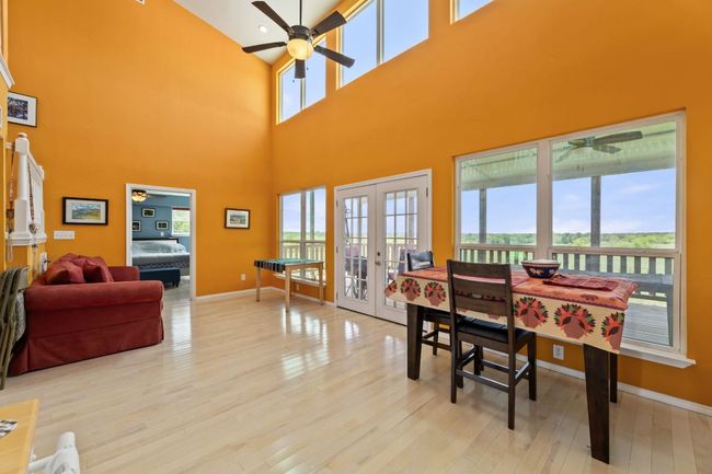 Dining room with light wood-type flooring, ceiling fan, and french doors | Image 12