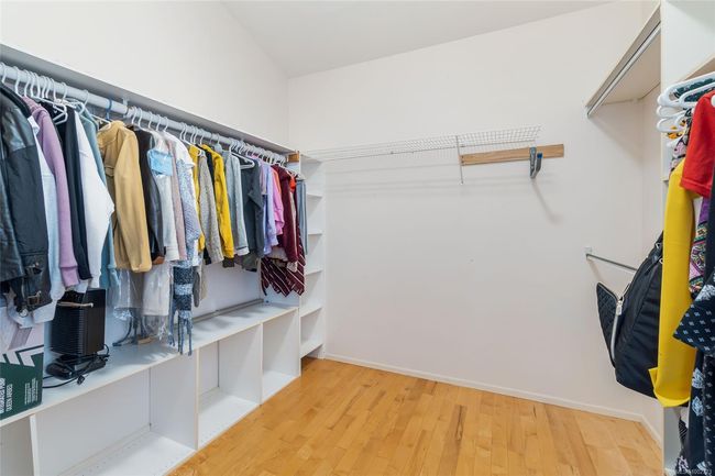 Walk in closet featuring wood finished floors | Image 35