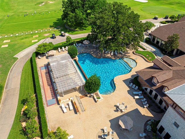 Community pool with view of golf course and a patio area at the community center | Image 37