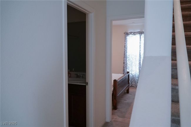 Hallway featuring stairway, light colored carpet, and a sink | Image 15