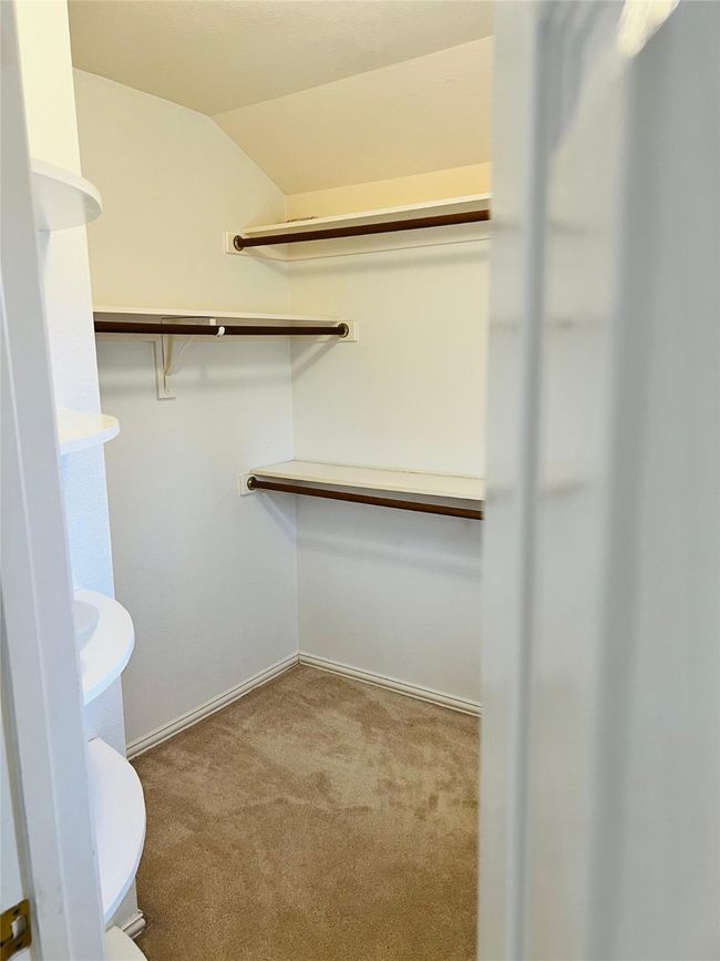 Spacious closet featuring lofted ceiling and carpet flooring | Image 19