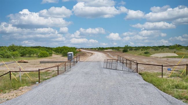 View of dirt / gravel driveway featuring a rural view and a gate | Image 14