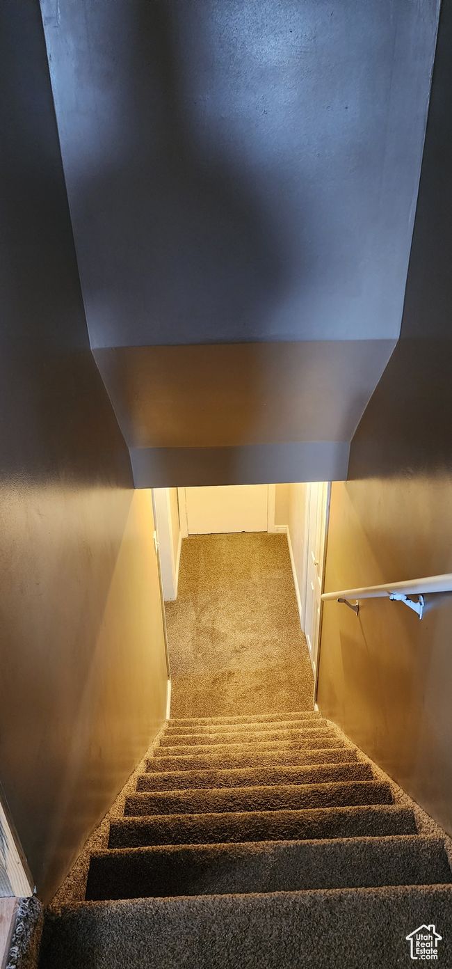 Stairway featuring lofted ceiling and carpet flooring | Image 19